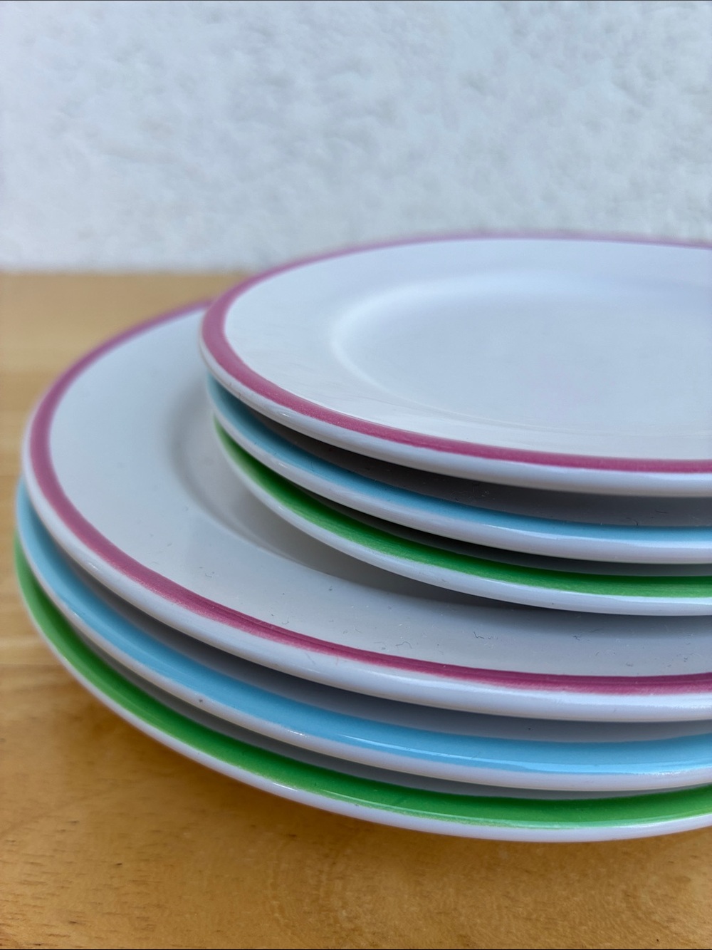 Set of small ceramic plates with smaller ceramic plates. White with pastel rim